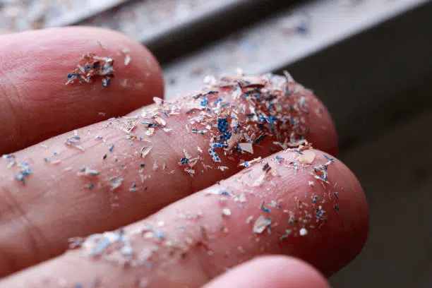 microplastics on a person's fingers